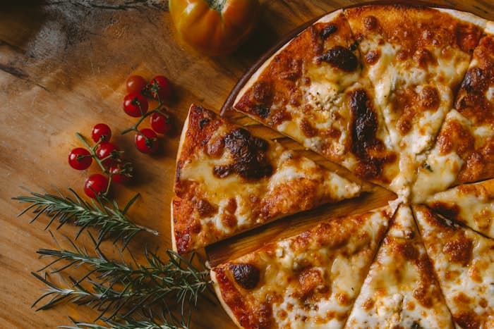 Sliced pizza on a wooden board